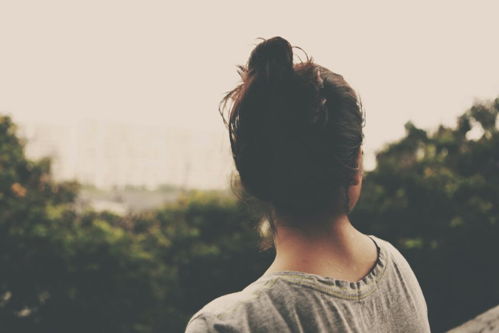 woman scenic view looking over treetops